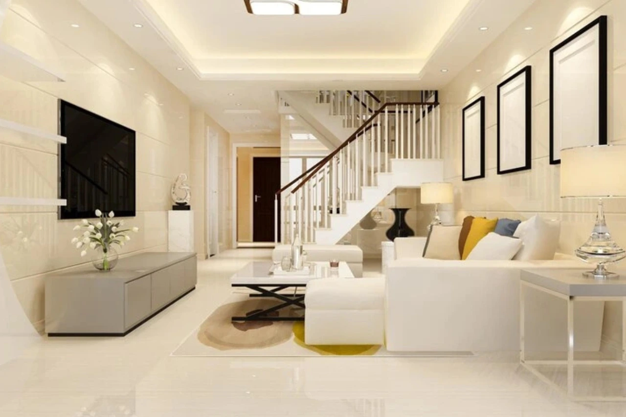 "Modern minimalist living room interior with white staircase, wall-mounted TV, and contemporary furniture"