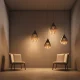 "Modern geometric pendant lights with hexagonal design illuminating minimalist seating area"